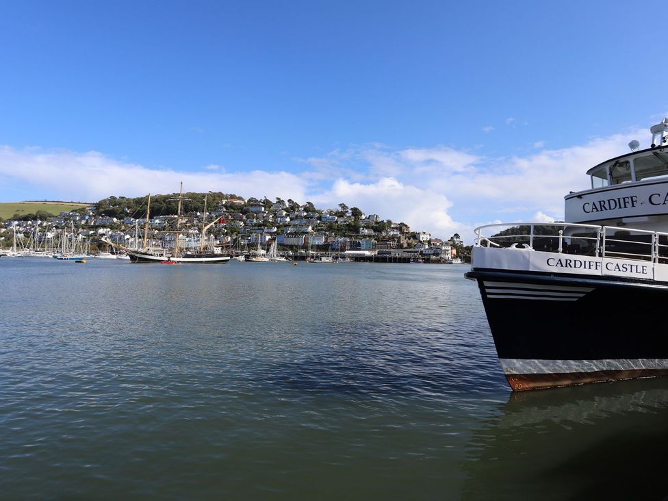 A boat in the water near buildings at Dart Views in Dartmouth