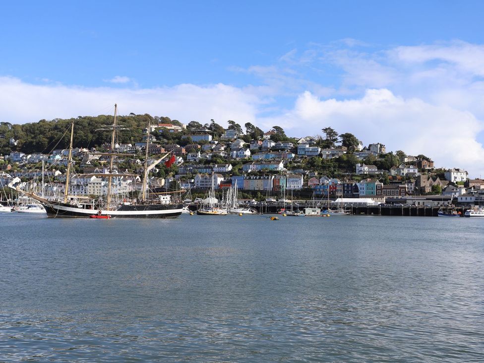 A marina with a ship and houses in the background at Dart Views in Dartmouth