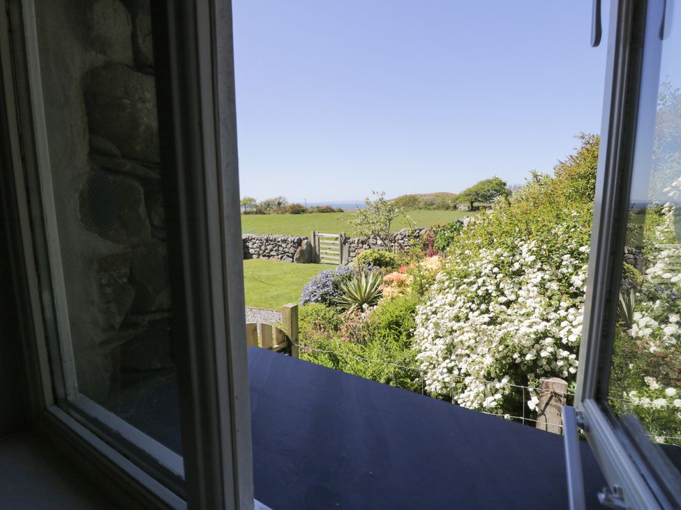 A view from a window overlooking a garden at Beudy Bach in Llanbedr