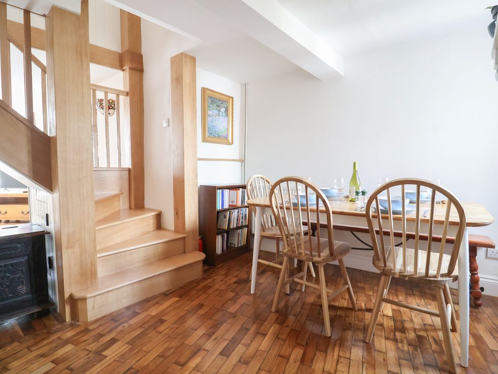 A dining room with a table and chairs at Saybrook Cottage in Charmouth