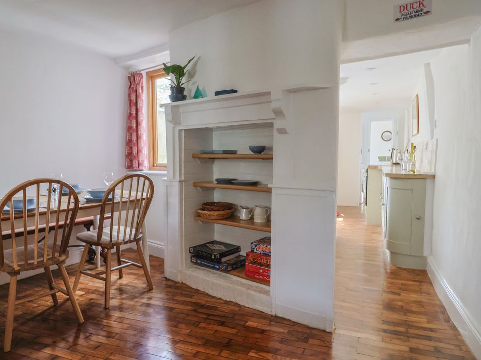 A dining room with a table and chairs at Saybrook Cottage in Charmouth