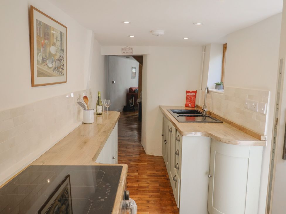 A kitchen with a countertop and sink at Saybrook Cottage in Charmouth