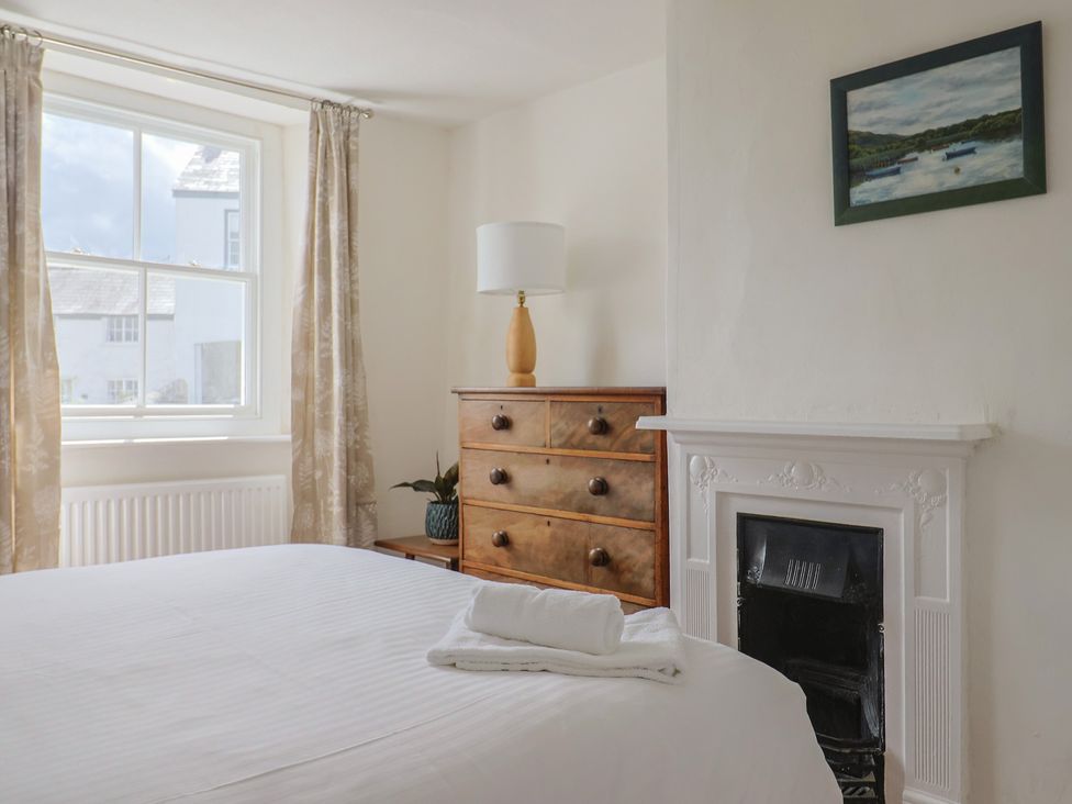 A bedroom with a bed and a lamp at Saybrook Cottage in Charmouth