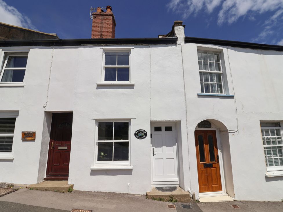 A house with multiple doors and windows at Saybrook Cottage in Charmouth