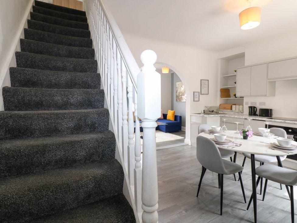 A living room with dining area and stairs at 22 Prospect Terrace in Brancepeth