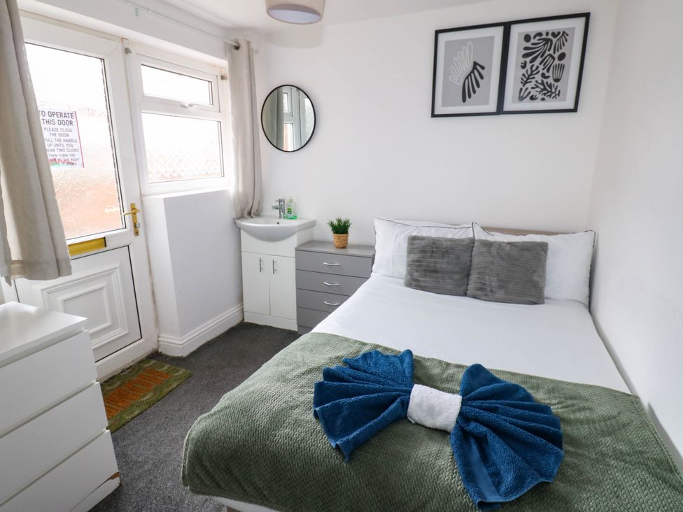 A bedroom with a bed and a mirror at 22 Prospect Terrace Brancepeth