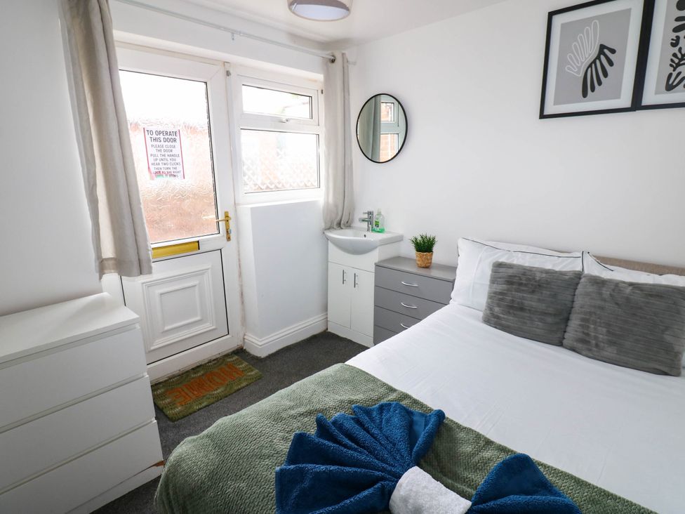 A bedroom with a bed and door at 22 Prospect Terrace Brancepeth