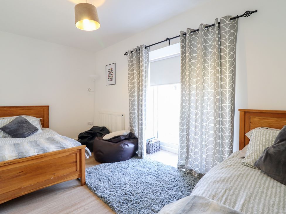 A bedroom with two beds and a bean bag at Tyn Y Weirglodd in Deiniolen