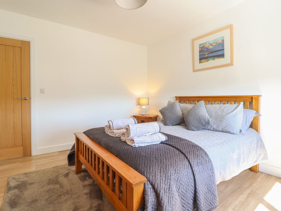 A bedroom with a bed and bedside table at Tyn Y Weirglodd in Deiniolen