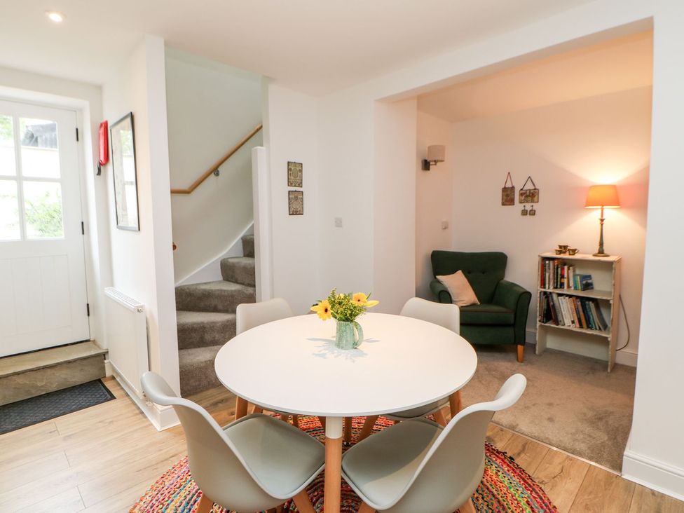 A dining room with a table and chairs at Dairy Cottage in Kirkby Stephen
