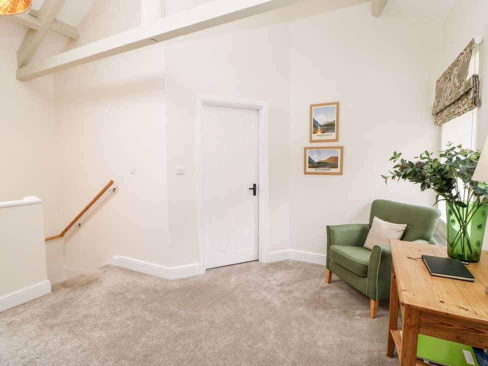 A landing with a chair and a table at Dairy Cottage in Kirkby Stephen
