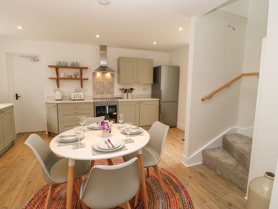 A kitchen with a dining table and chairs at Dairy Cottage in Kirkby Stephen