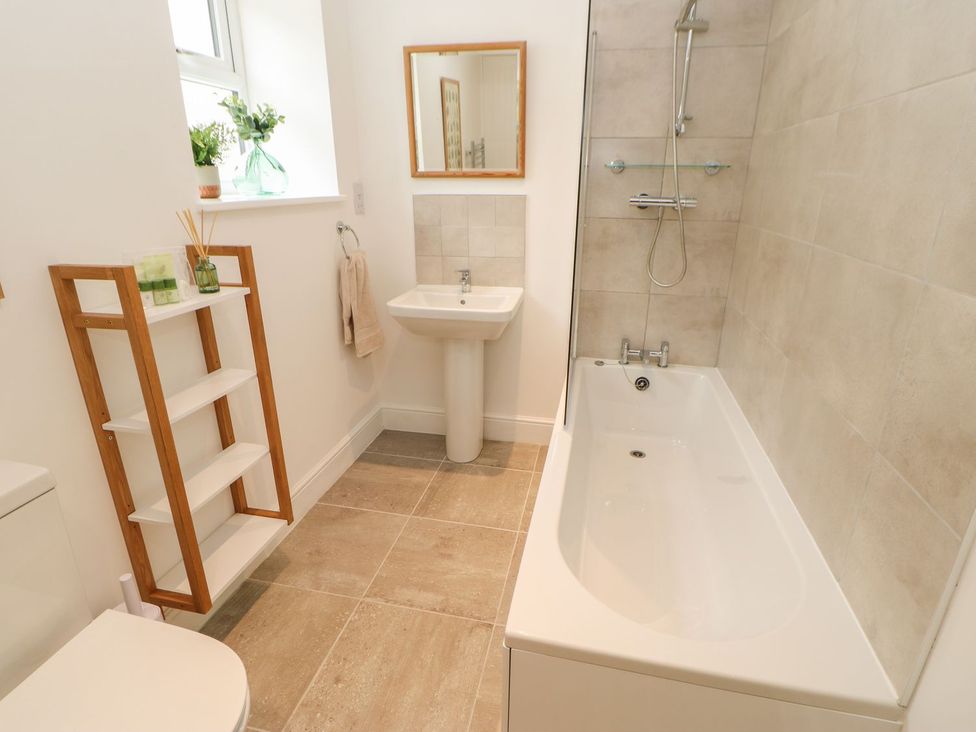 A bathroom with a sink and bathtub at Dairy Cottage Kirkby Stephen
