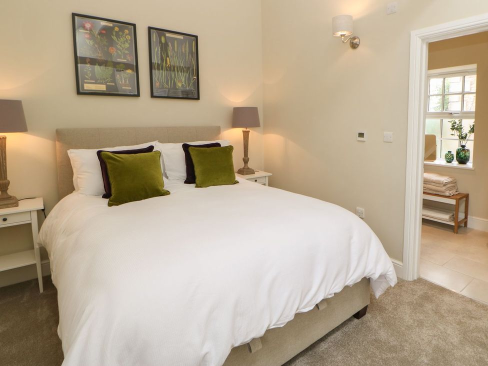 A bedroom with a bed and lamps at Dairy Cottage Kirkby Stephen