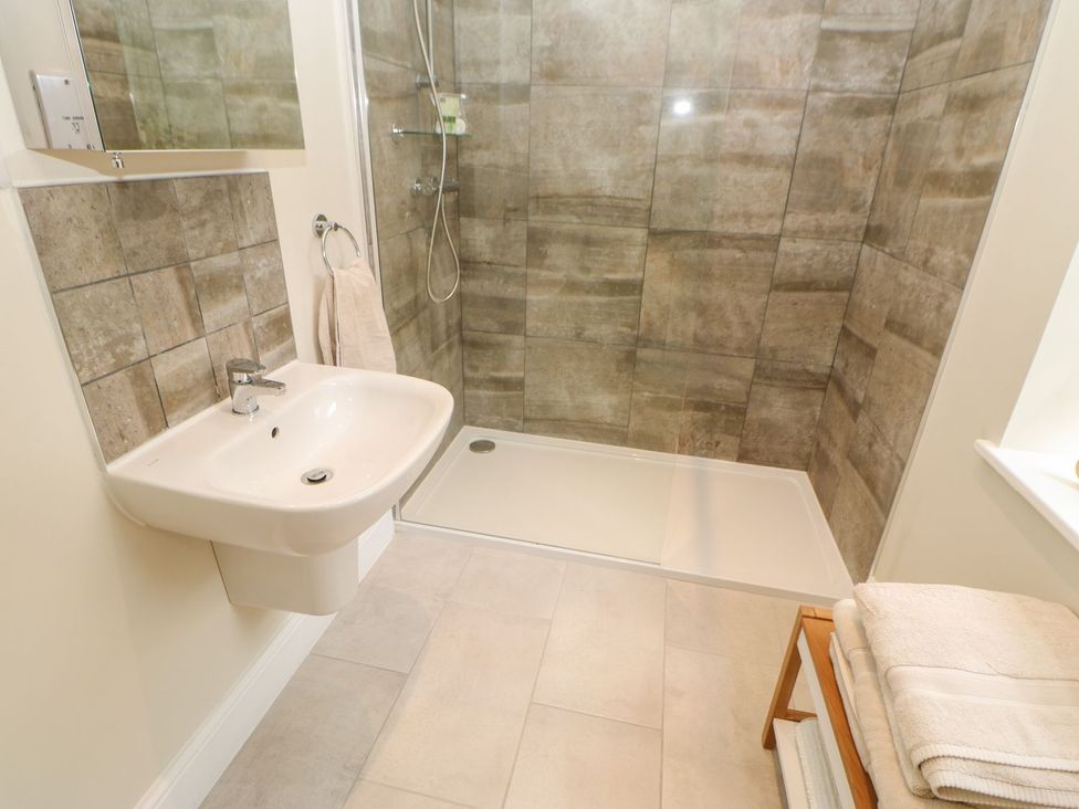 A bathroom with a shower and sink at Dairy Cottage in Kirkby Stephen