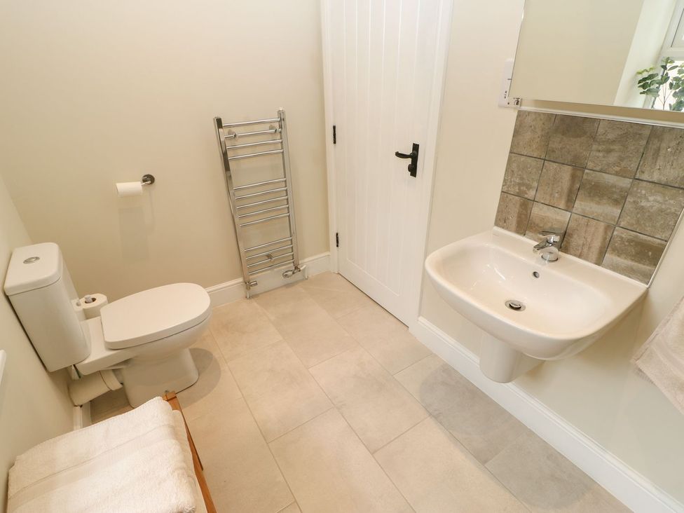 A bathroom with a toilet and sink at Dairy Cottage Kirkby Stephen