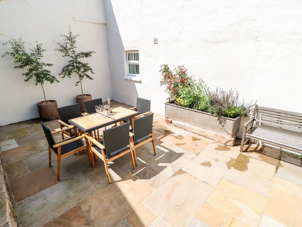 An outdoor area with a table and chairs at Dairy Cottage in Kirkby Stephen