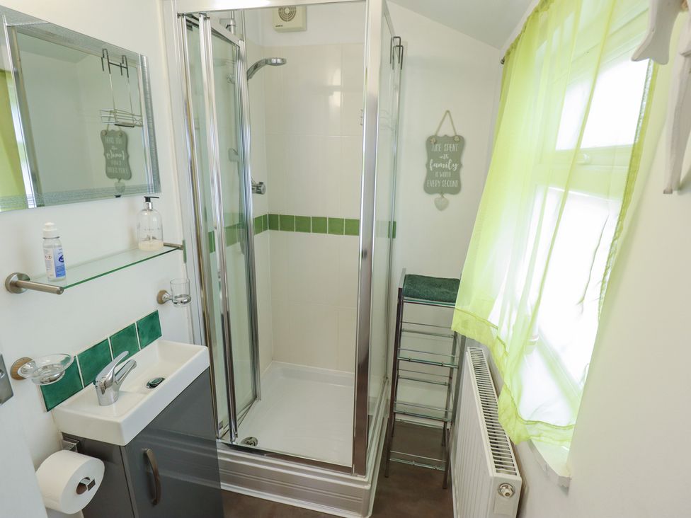 A bathroom with a shower and sink at Pankhurst Cottage Louth
