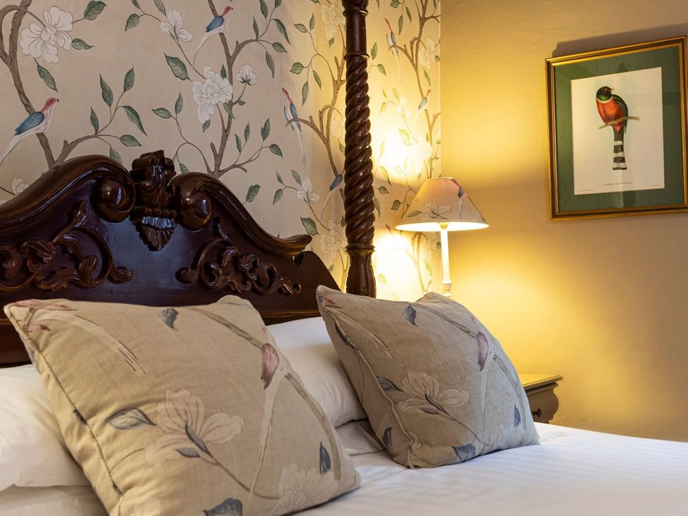 A bedroom with a bed and bedside lamp at Lonsdale House Bowness-On-Windermere