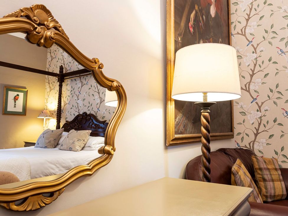 A bedroom with a bed and a lamp at Lonsdale House Bowness-On-Windermere