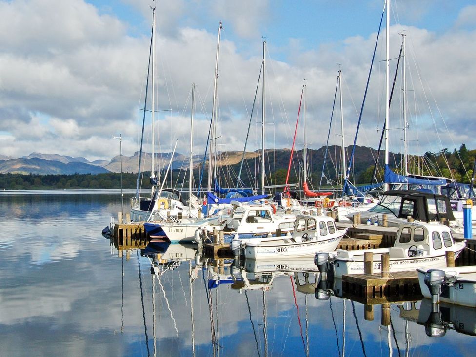 A marina with boats docked at Lonsdale House Bowness-On-Windermere