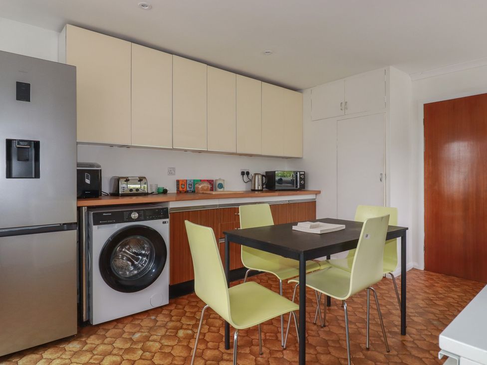 A kitchen with appliances and furniture at 7 Chycoose Parc
