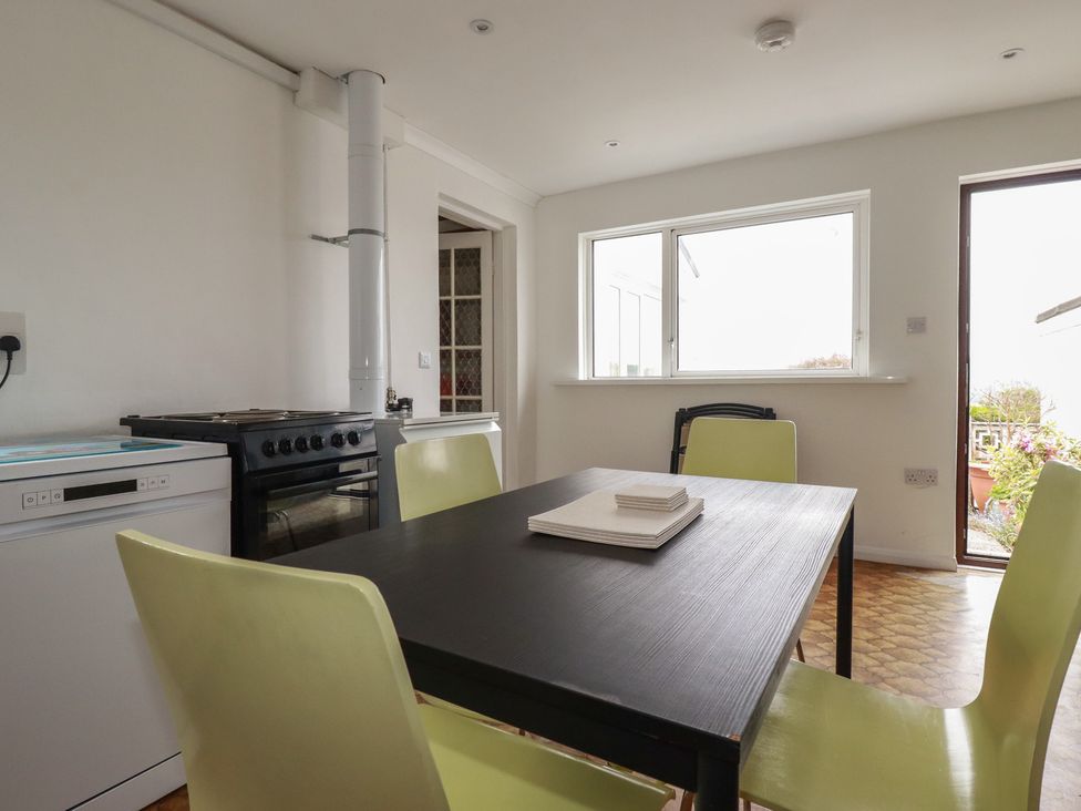 A kitchen with a dining table and chairs at 7 Chycoose Parc 