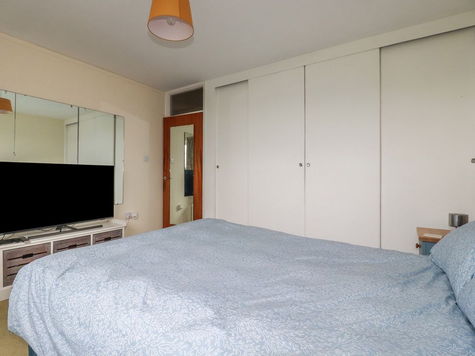 A bedroom with a bed and television at 7 Chycoose Parc