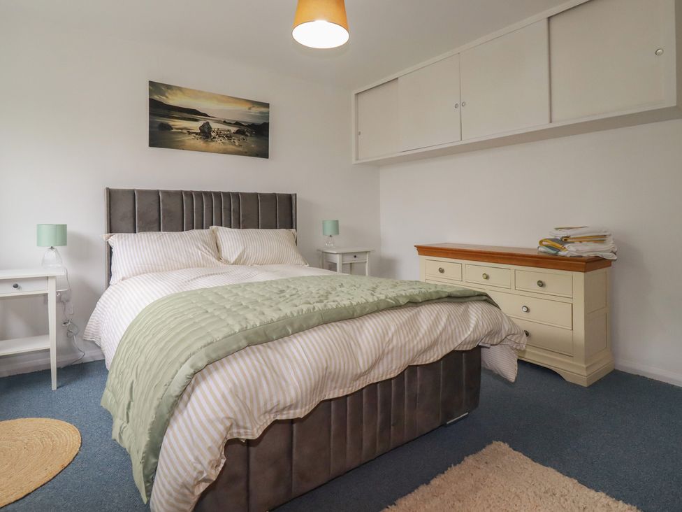 A bedroom with a bed and bedside tables at 7 Chycoose Parc