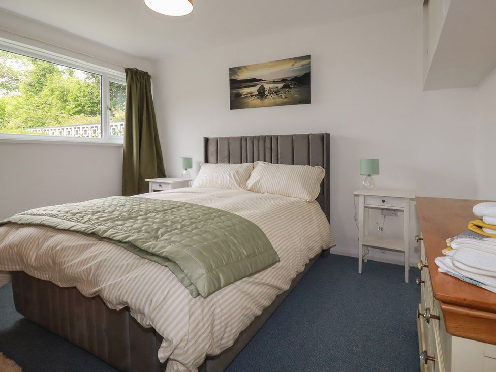 A bedroom with a bed and bedside tables at 7 Chycoose Parc in 