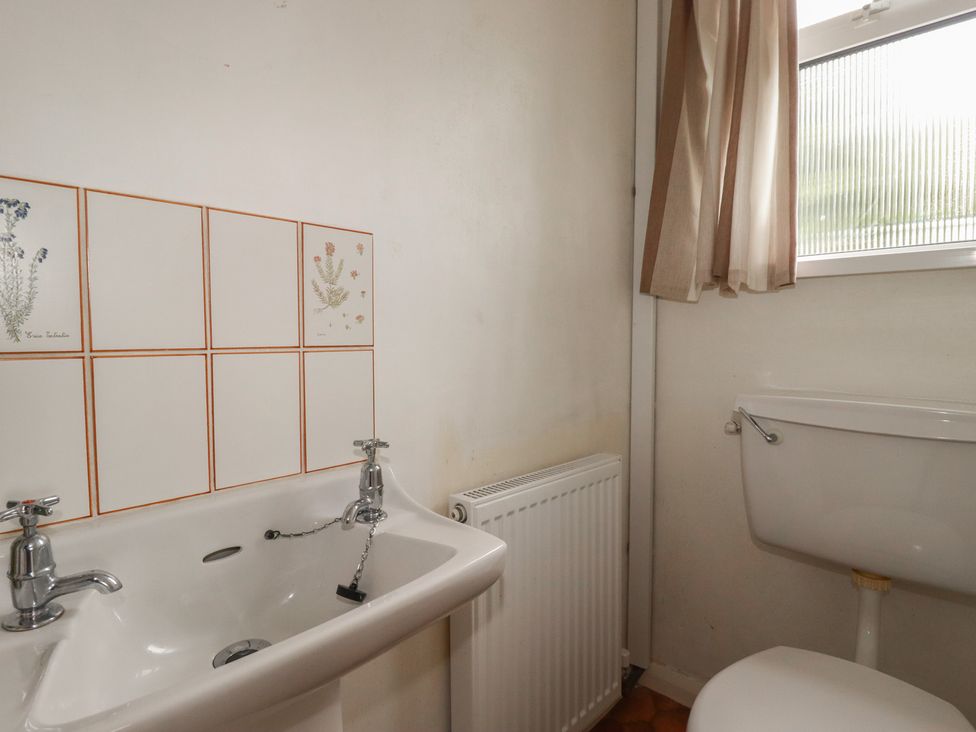 A bathroom with a sink and toilet at 7 Chycoose Parc