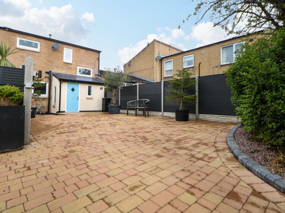A garden with a bench and planters at 49 Rushley Road in Sheffield