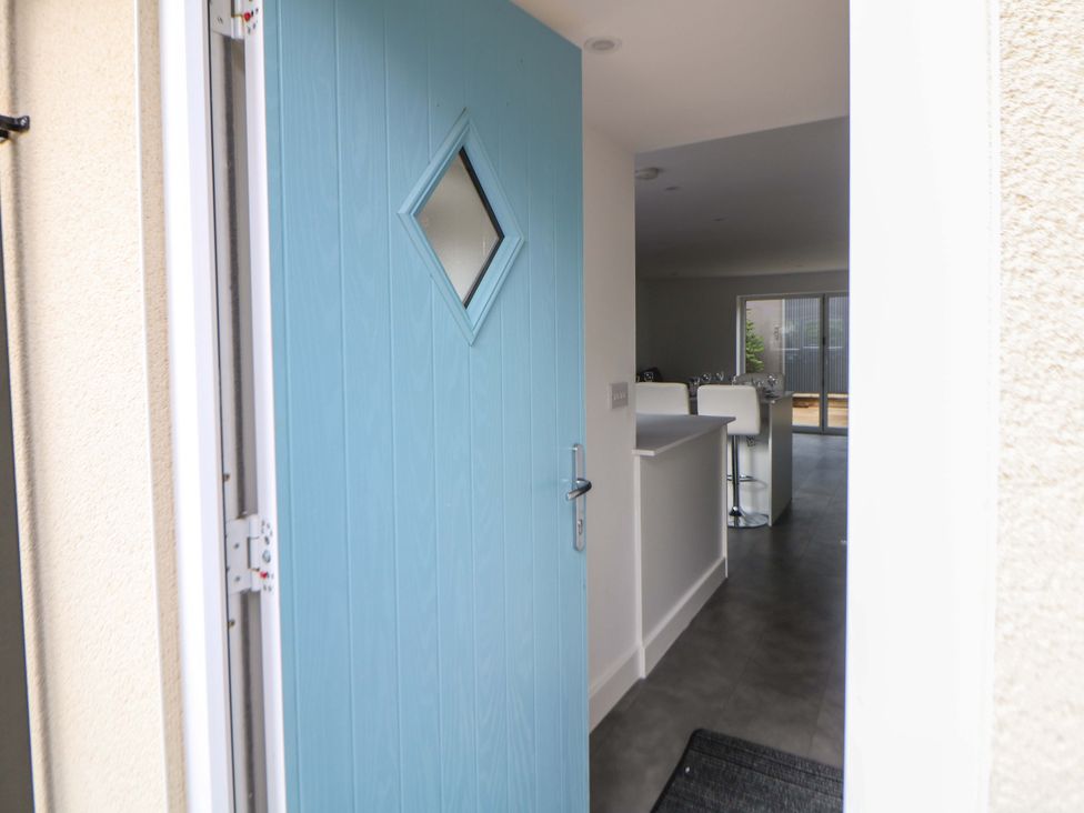 An entryway with a blue door and a view into a kitchen at 49 Rushley Road Sheffield
