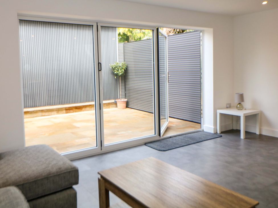A living room with sliding doors to the garden at 49 Rushley Road in Sheffield