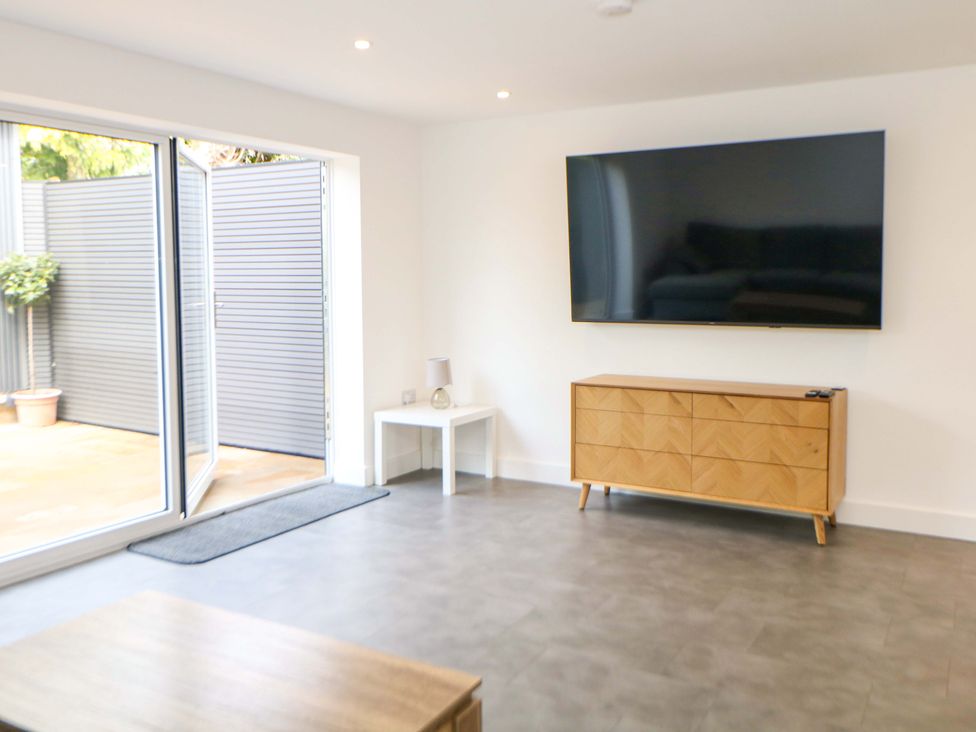 A living room with a television and furniture at 49 Rushley Road in Sheffield