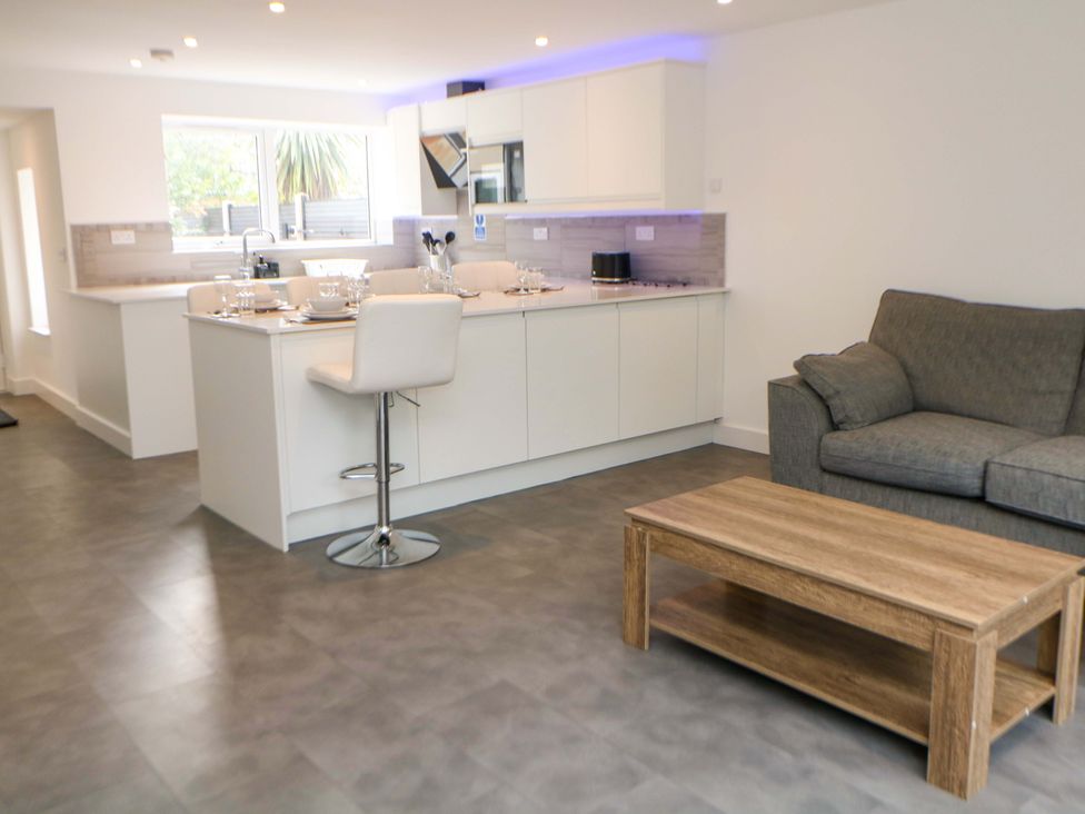 An open plan living space with kitchen island and sofa at 49 Rushley Road in Sheffield
