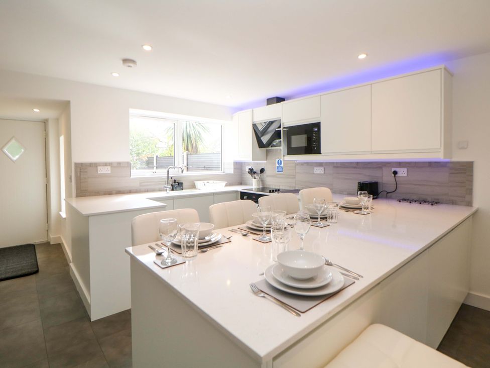 A kitchen with countertop and dining area at 49 Rushley Road in Sheffield