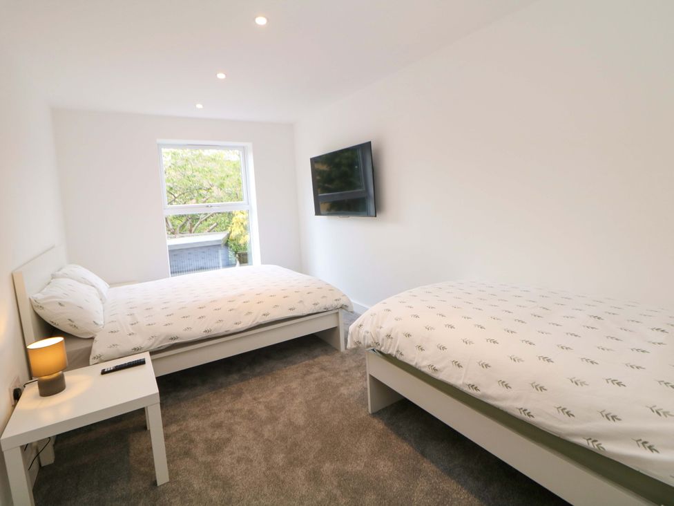 A bedroom with two beds and a television at 49 Rushley Road in Sheffield