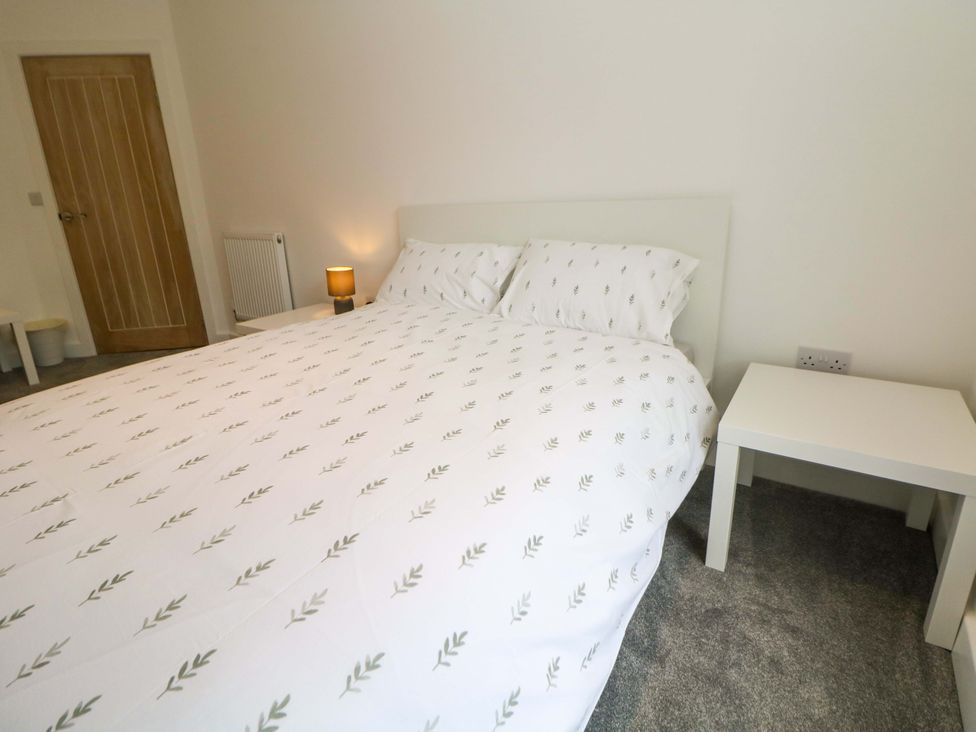 A bedroom with a bed and bedside table at 49 Rushley Road in Sheffield
