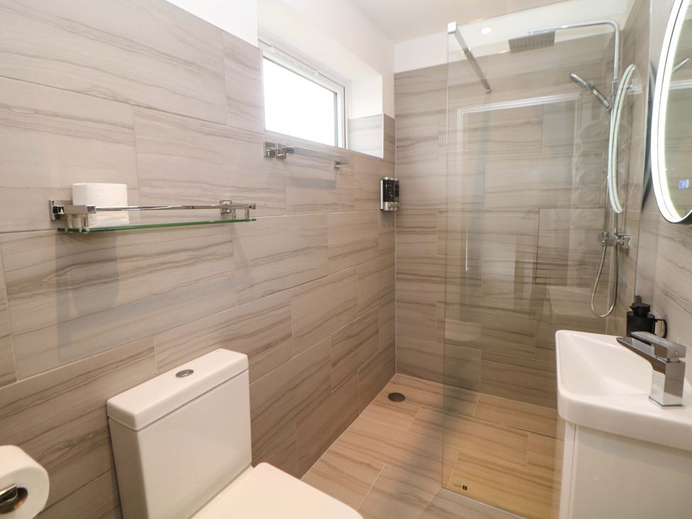 A bathroom with a shower, toilet, and sink at 49 Rushley Road Sheffield