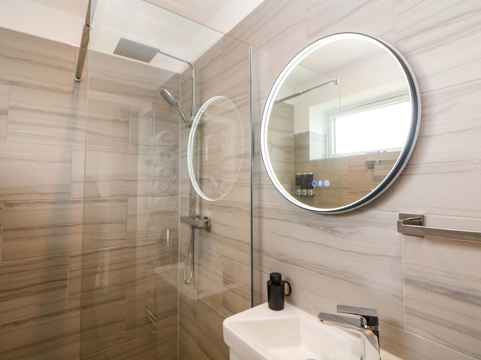 A bathroom with a shower and sink at 49 Rushley Road in Sheffield