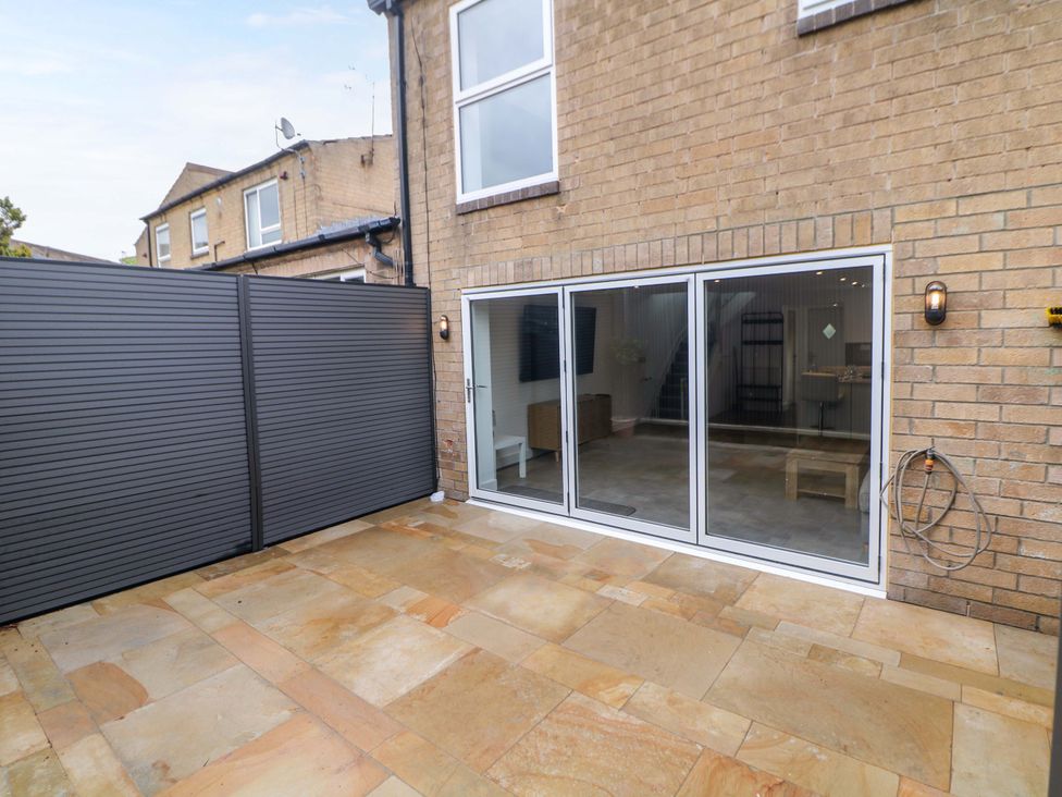 A garden with sliding doors and patio area at 49 Rushley Road Sheffield