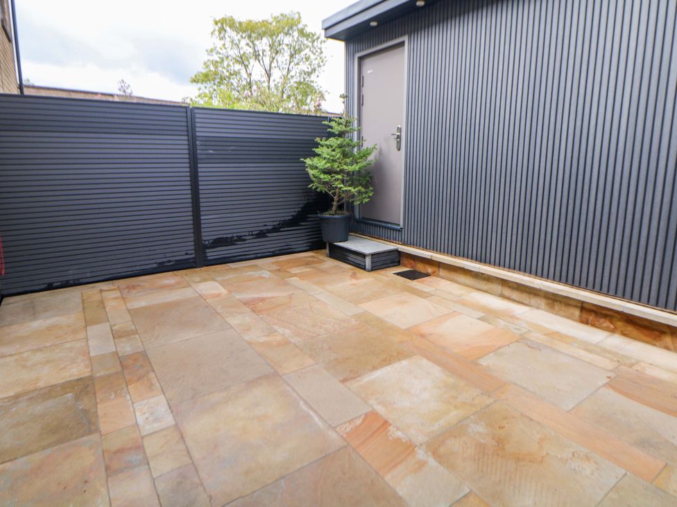 An outdoor area with stone flooring and a potted plant at 49 Rushley Road Sheffield