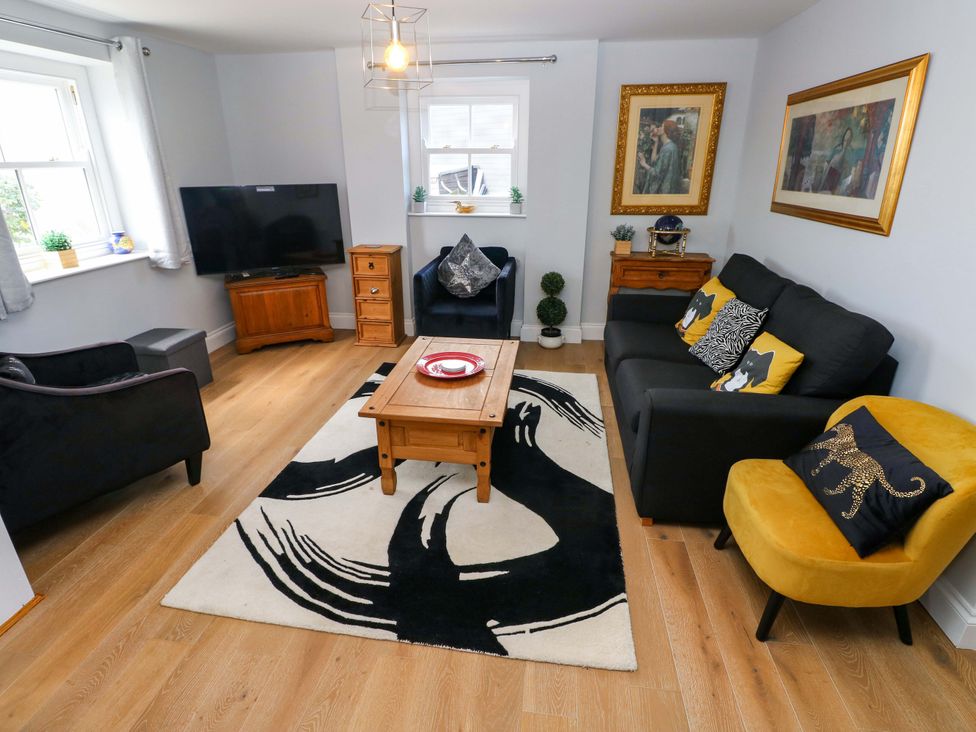 A living room with a coffee table and sofa at Newgale Cottage Haverfordwest