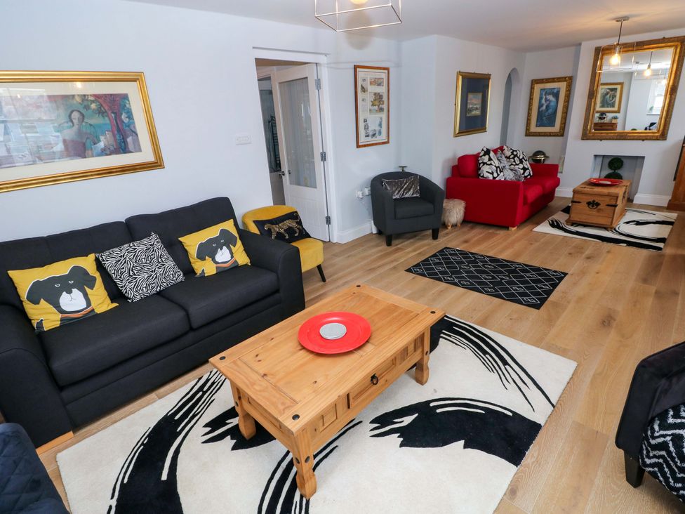 A living room with a sofa and coffee table at Newgale Cottage in Haverfordwest