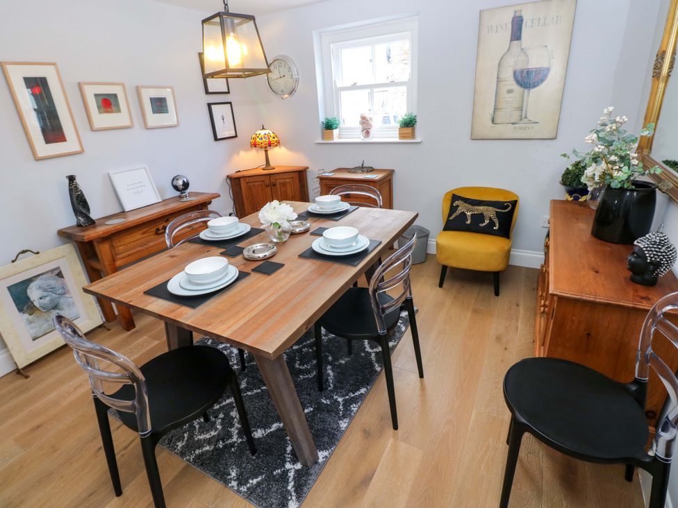 A dining room with table and chairs at Newgale Cottage in Haverfordwest