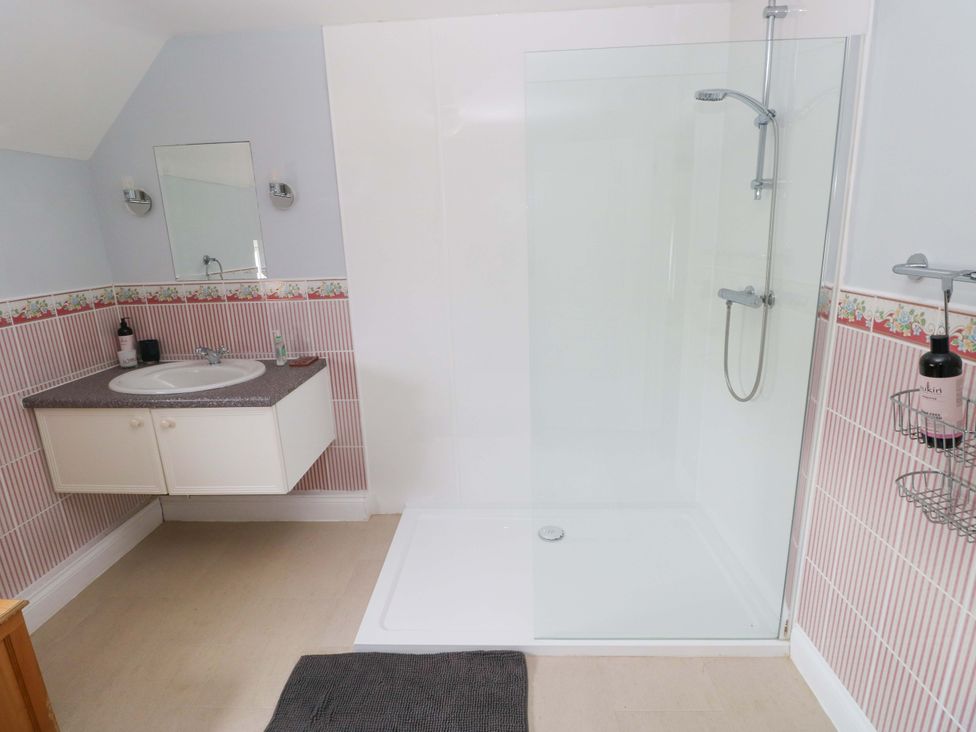 A bathroom with sink and shower at Newgale Cottage Haverfordwest