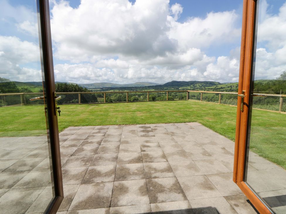 An outdoor area with grass and mountains visible at Yr Onnen