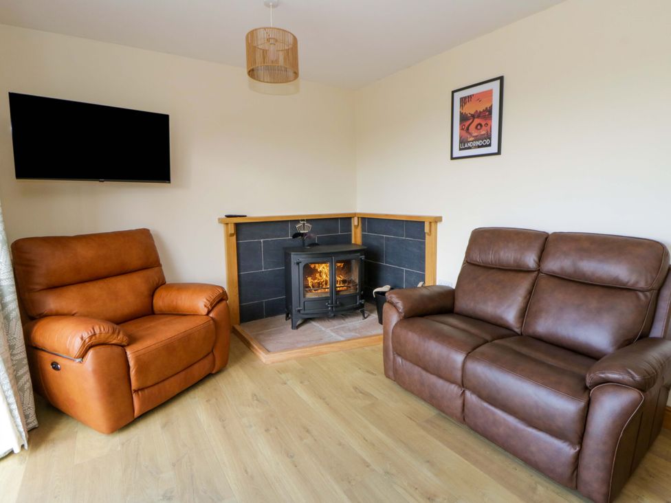 A living room with two sofas and a fireplace at Yr Onnen 
