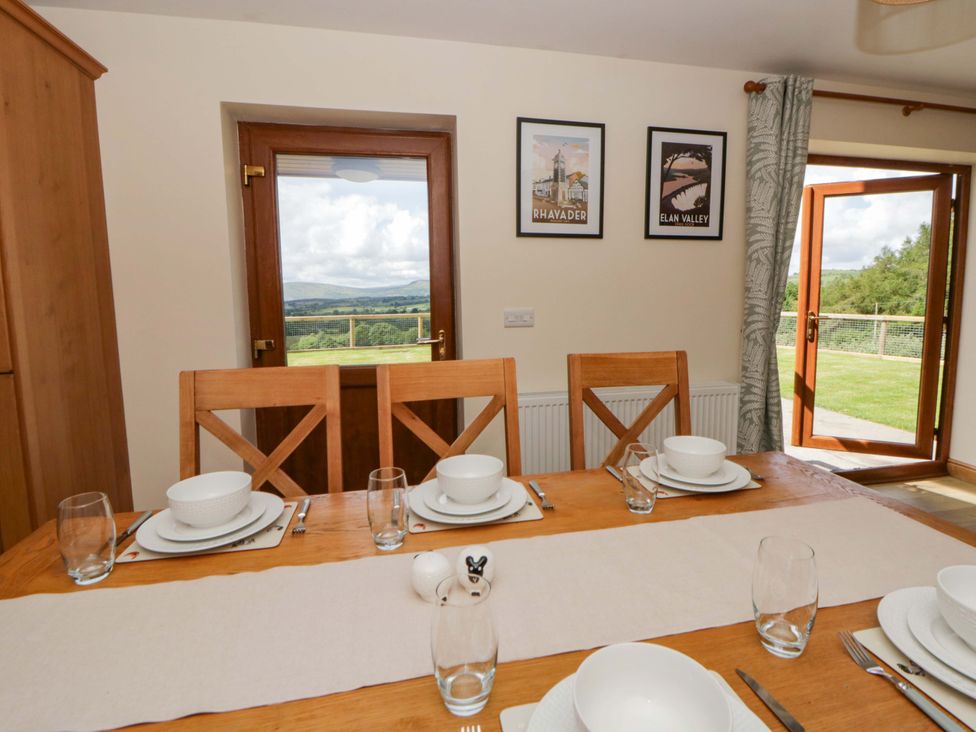 A dining room with a table set for a meal at Yr Onnen